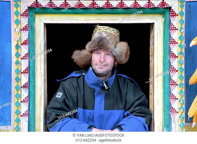 a German tourist in a traditionel tibetan house