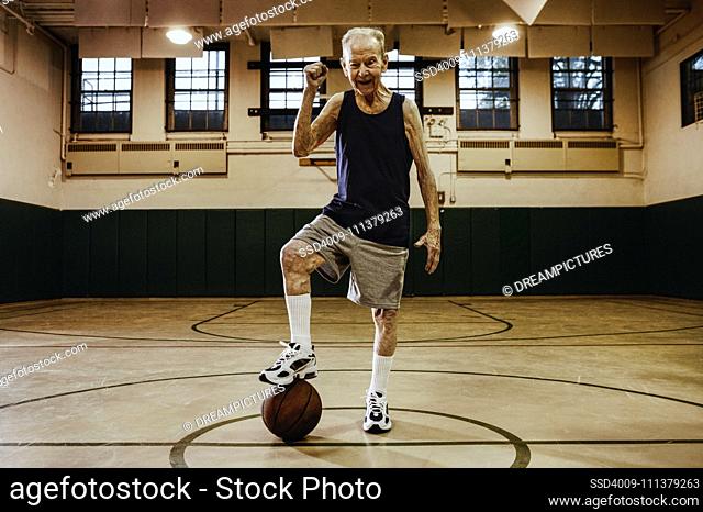 Elderly man playing basketball