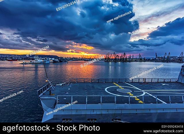 Part of the frigate, a helicopter landing at sunset in the harbor. military ship. Marine forces