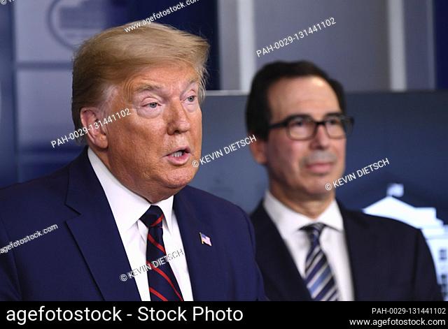 United States President Donald J. Trump with United States Secretary of the Treasury Steven T. Mnuchin delivers remarks during a Coronavirus briefing at the...