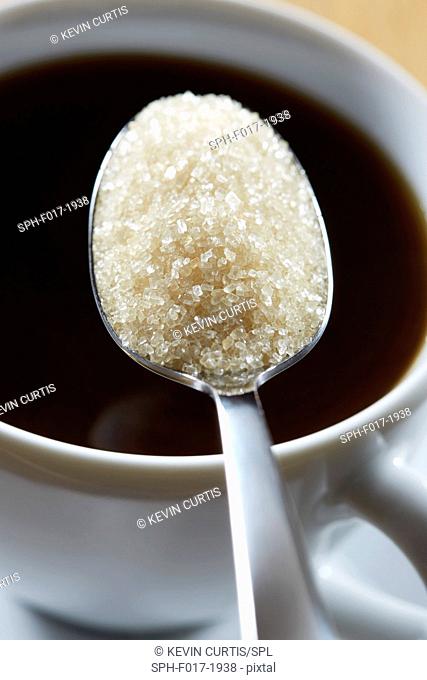 Spoonful of sugar and hot drink, close up