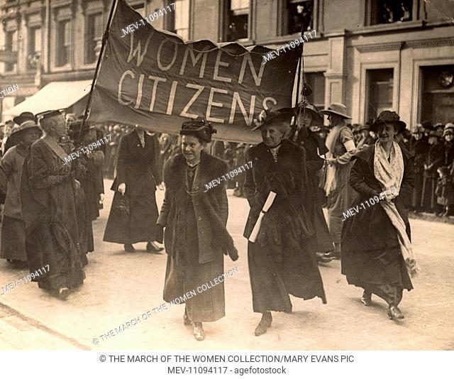 Photograph shows Millicent Garrett Fawcett ahead of a banner proclaiming 'Woman Citizens' Mrs. Fawcett, President of the National Union of Women's Suffrage...