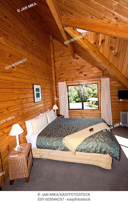 Nice warm interior of mountain wooden lodge double bedroom Fox Glacier Lodge, Fox Glacier, West Coast, South Island, New Zealand
