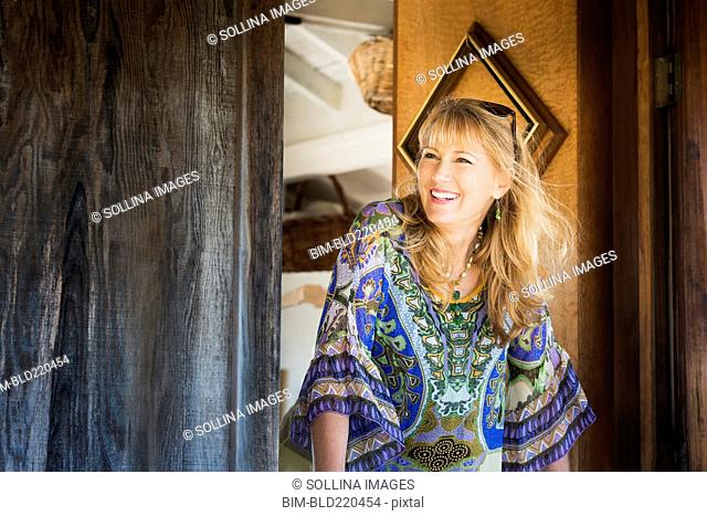 Caucasian woman smiling in doorway