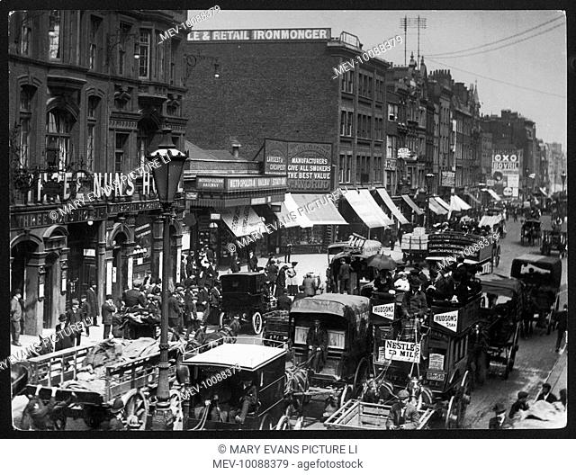 A traffic block in Aldgate High street, east London. Note the predominance of horse- drawn over motorised vehicles; Aldgate tube station and the Three Nuns...