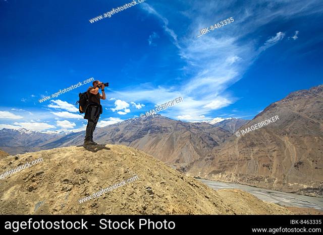 Photographer taking photos in Himalayas mountains. Spiti valley, Himachal Pradesh, India, Asia