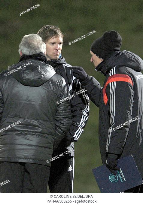 DFB Head Instructor Frank Wormuth (r) and examiner Bernd Stoeber (l) talking to Hoffenheim's coach Julian Nagelsmann (c) after his practical examination for his...