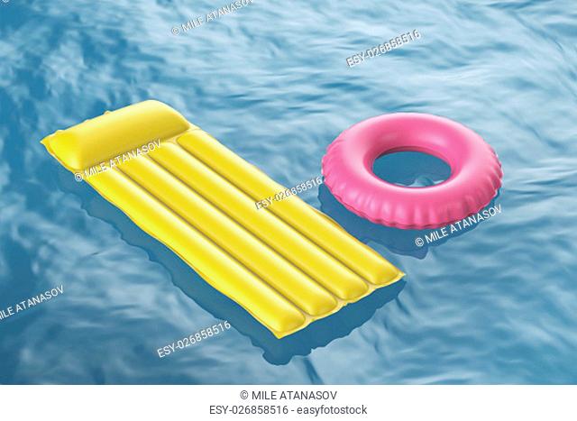 Pool raft and swim ring floating on wavy water