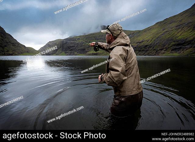 Man fly fishing in lake