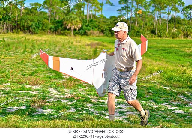 Instructor Gene Payson holds a classic flying wing at a small unmanned aircraft pilot training course at the Unmanned Vehicle University