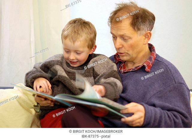 Father reading to his little five year old boy a picture book picture-book