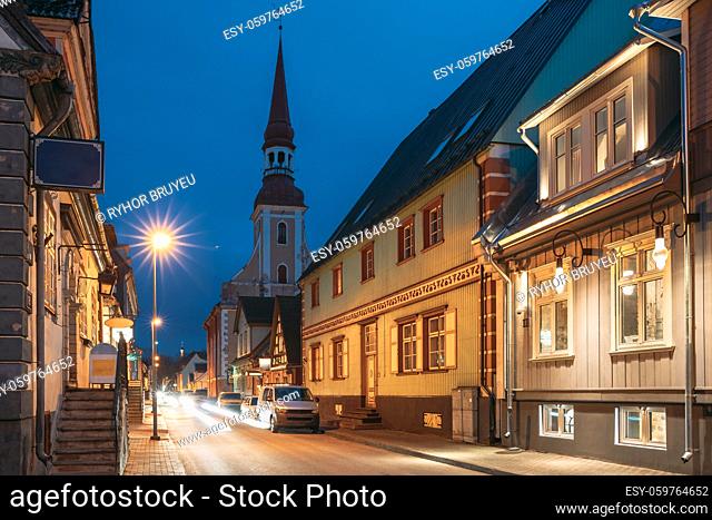 Parnu, Estonia. Night View Of Puhavaimu Street With Old Wooden Houses, Restaurants, Cafe, Hotels And Shops In Evening Night Illuminations