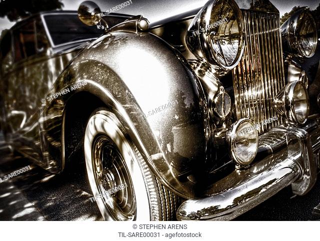 A vintage Rolls Royce motorcar with gleaming chrome grill and bumper