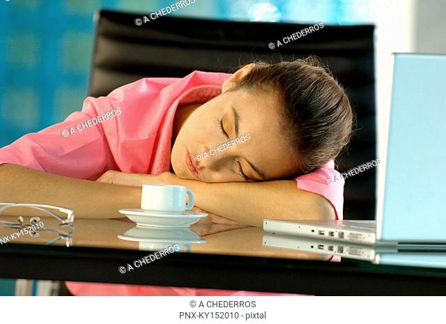 Young businesswoman relaxing on glass desk