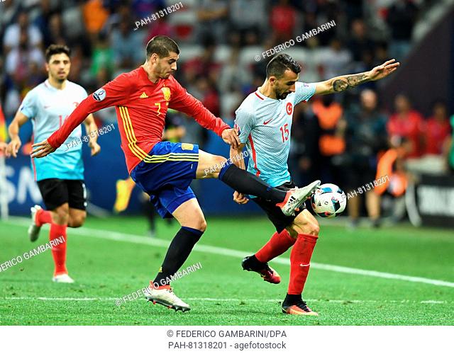 Alvaro Morata (L) of Spain vies for the ball with Mehmet Topal of Turkey during the Group D soccer match of the UEFA EURO 2016 between Spain and Turkey at the...