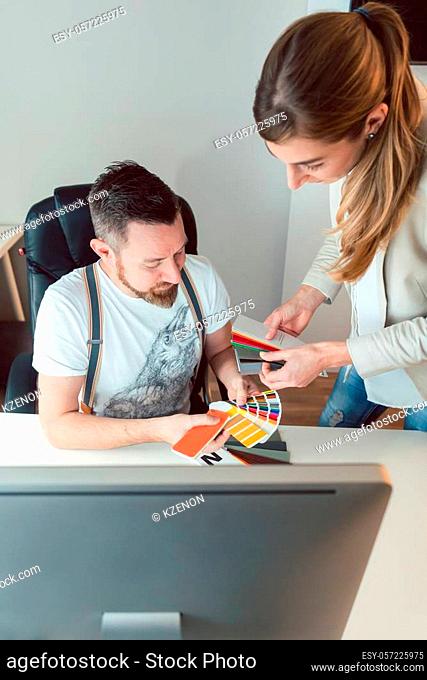 Creatives working in team checking colors for advertising project in the agency