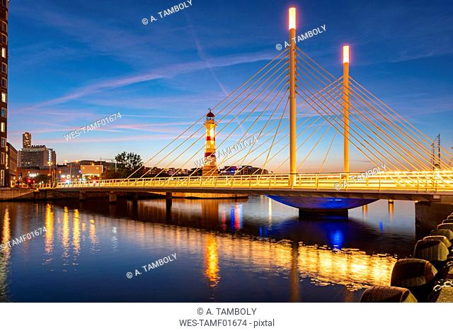 Illuminated bridge over river against sky at Malmo, Sweden