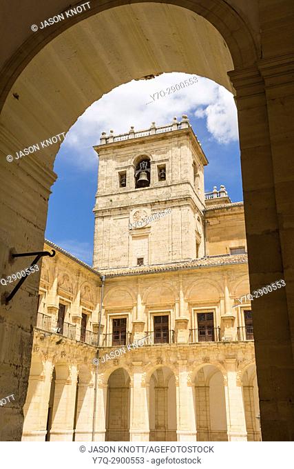 One of the two towers viewed through a courtyard arch of the Monastery of Ucles, Ucles, Castile-La Mancha, Spain