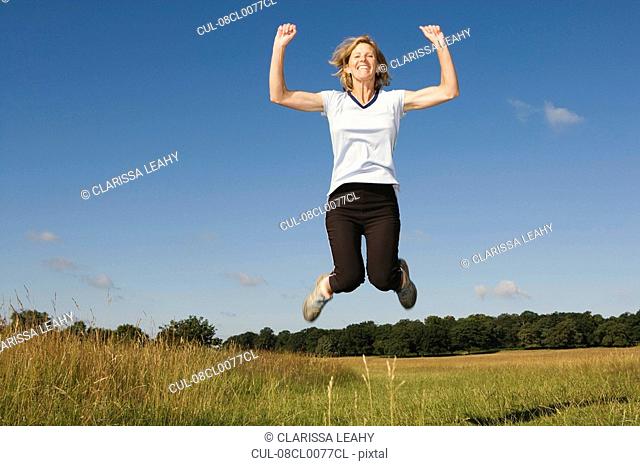 Woman runner jumping in air