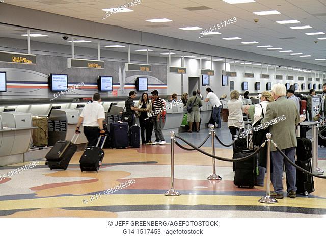 Florida, Miami, Miami International Airport, MIA, aviation, terminal, American Airlines, US carrier, company, ticket counter, roped line, queue, wait, man