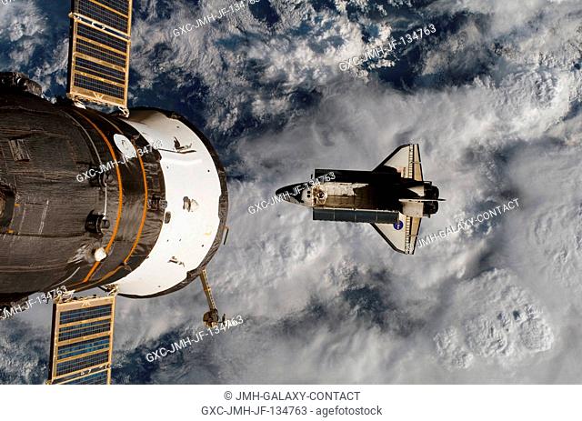 Backdropped over a cloud-covered part of Earth, Space Shuttle Atlantis is featured in this image photographed by an Expedition 15 crewmember after the shuttle...