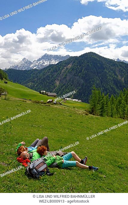 Italy, Alto Adige, family resting in the Campill valley