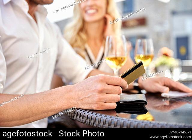 close up of couple with credit card and bill at restaurant