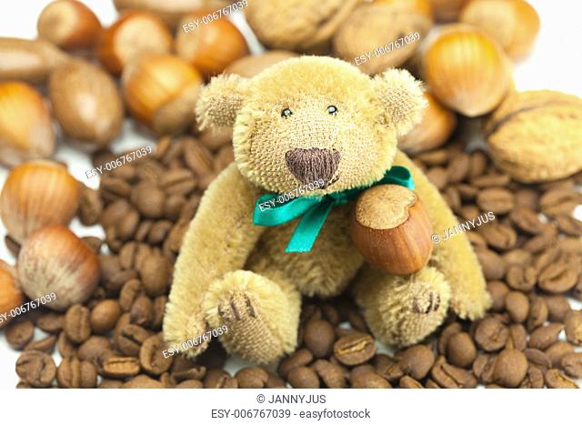 teddy bear with a bow, coffee beans and nuts