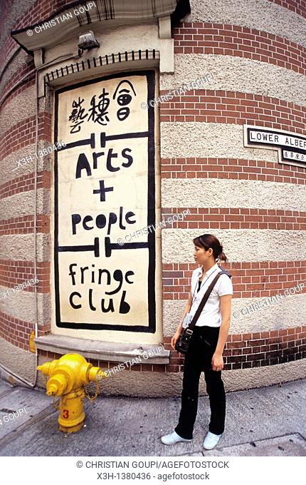 young woman in front of The Hong Kong Fringe Club, Central District, Hong-Kong Island, People's Republic of China, Asia