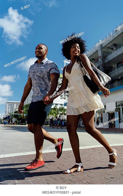 USA, Florida, Miami Beach, happy young couple crossing the street