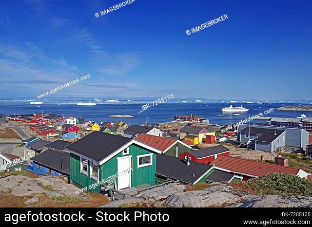 Houses and public buildings, cruise ship in a bay with icebergs, Ilulissat, Disko Bay, Arctic, Greenland, Denmark, North America