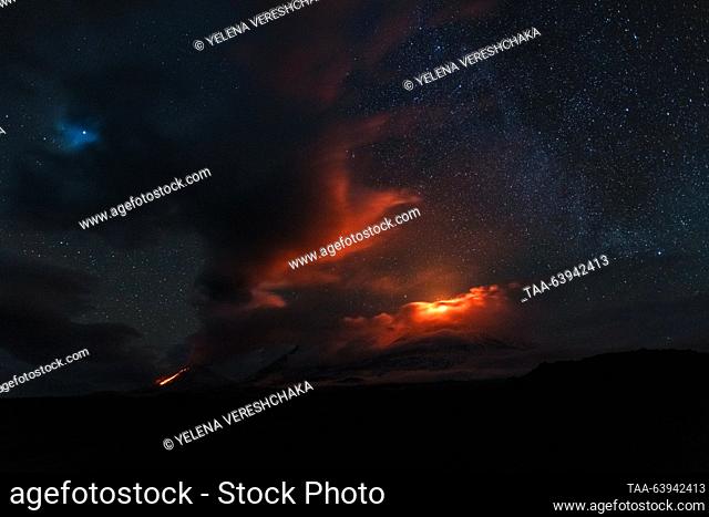 RUSSIA, KAMCHATKA REGION - OCTOBER 23, 2023: A view of Kamen dormant stratovolcano and erupting Klyuchevskaya Sopka (Klyuchevskoi) and Bezymyanny active...