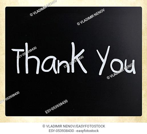 """""Thank you"" handwritten with white chalk on a blackboard