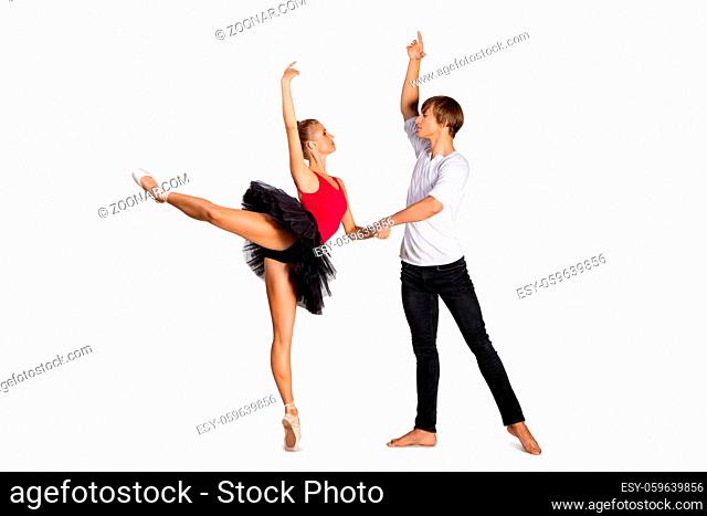 Beautiful young couple dancing ballet over white background