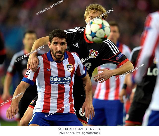 Leverkusen's Simon Rolfes (R) and Madrid's Raúl Garcia vie for the ball during the UEFA Champions League Round of 16 second leg soccer match between Bayer...