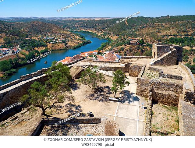The view from the Keep tower of Mertola Castle into the inner castle courtyard and the surrounding hills and Guadiana river. Mertola. Portugal