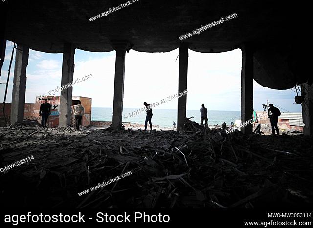 Palestinians inspect a wedding hall that was damaged in the aftermath of Israeli raids on Gaza City. Palestine