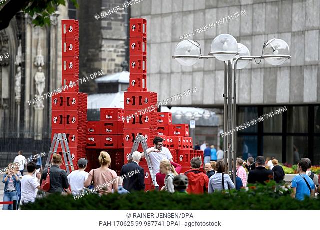 Students of architecture built a model of the Cologne cathedral from beer crates next to the original in Cologne, Germany, 25 June 2017