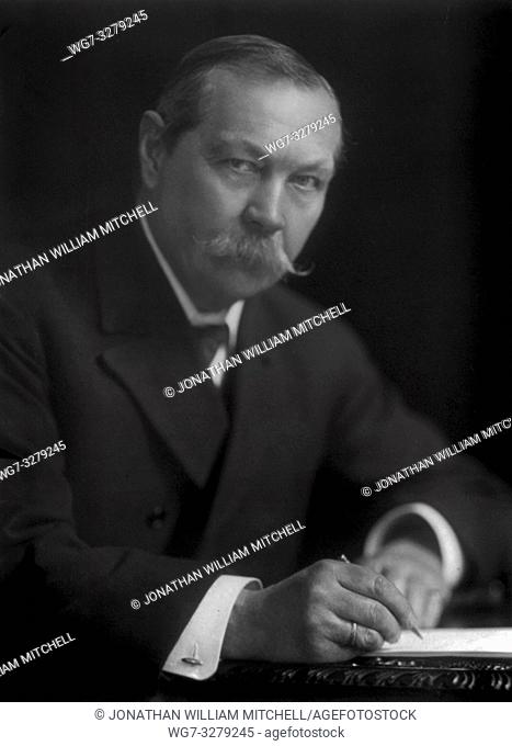 Portrait of Sir Arthur Conan Doyle ( 1859-1930 ) circa 1910 sitting at his desk with pen and paper. Sir Arthur was the author of the famous Sherlock Holmes...