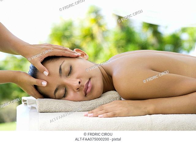 Woman having her head massaged