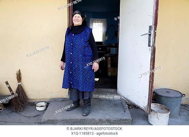Old farmer outside her old house. She now lives in a newer farmhouse. Gmina Przylek, Zwolen county, Poland
