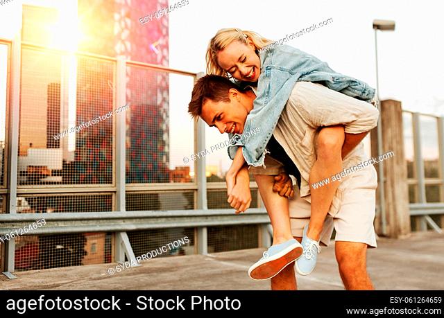happy young couple having fun on roof top parking