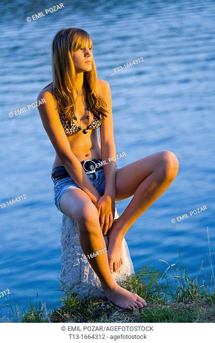 Young woman is watching sunset