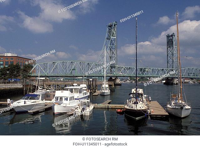 Portsmouth, NH, New Hampshire, Boats docked along the Piscataqua River in Portsmouth. View of Memorial Bridge crossing the Piscataqua River