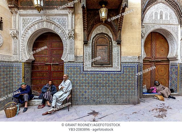 Men sitting outside Mosque Sidi Ahmed Tijani, The Medina, Fez, Morocco