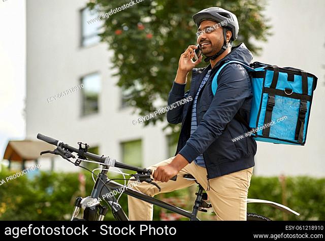 food delivery man with bag calling on smartphone