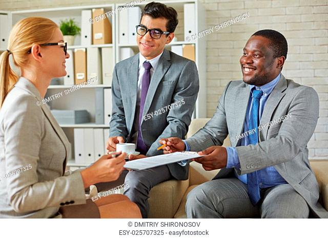 Businessmen reaching out contract to a woman