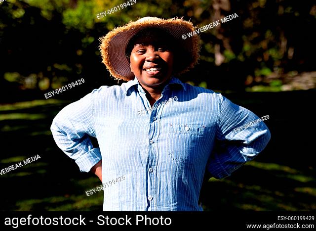 Portrait of happy african american senior woman taking photo outdoors