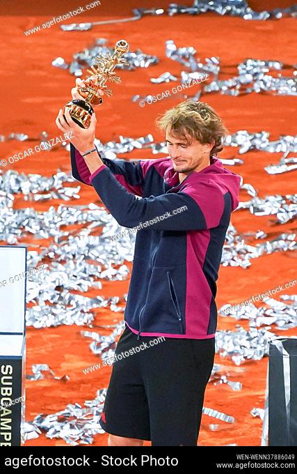 Alexander Zverev of Germany celebrates with the trophy following victory against Matteo Berrettini of Italy in the Mutua Madrid Open Final on day eleven of the...