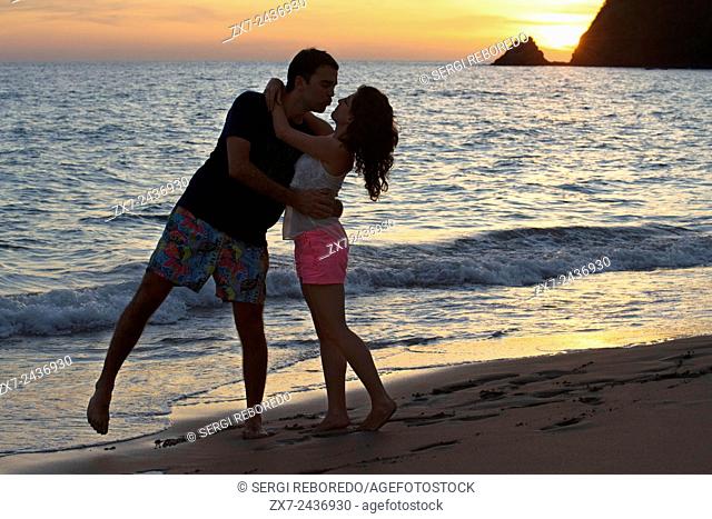 Couple lovers kissing at sunset in the beach. Kantiang Bay. Koh Lanta. Thailand. Asia. Kantiang Bay is most famous as the location of Pimalai, Koh Lantaâ